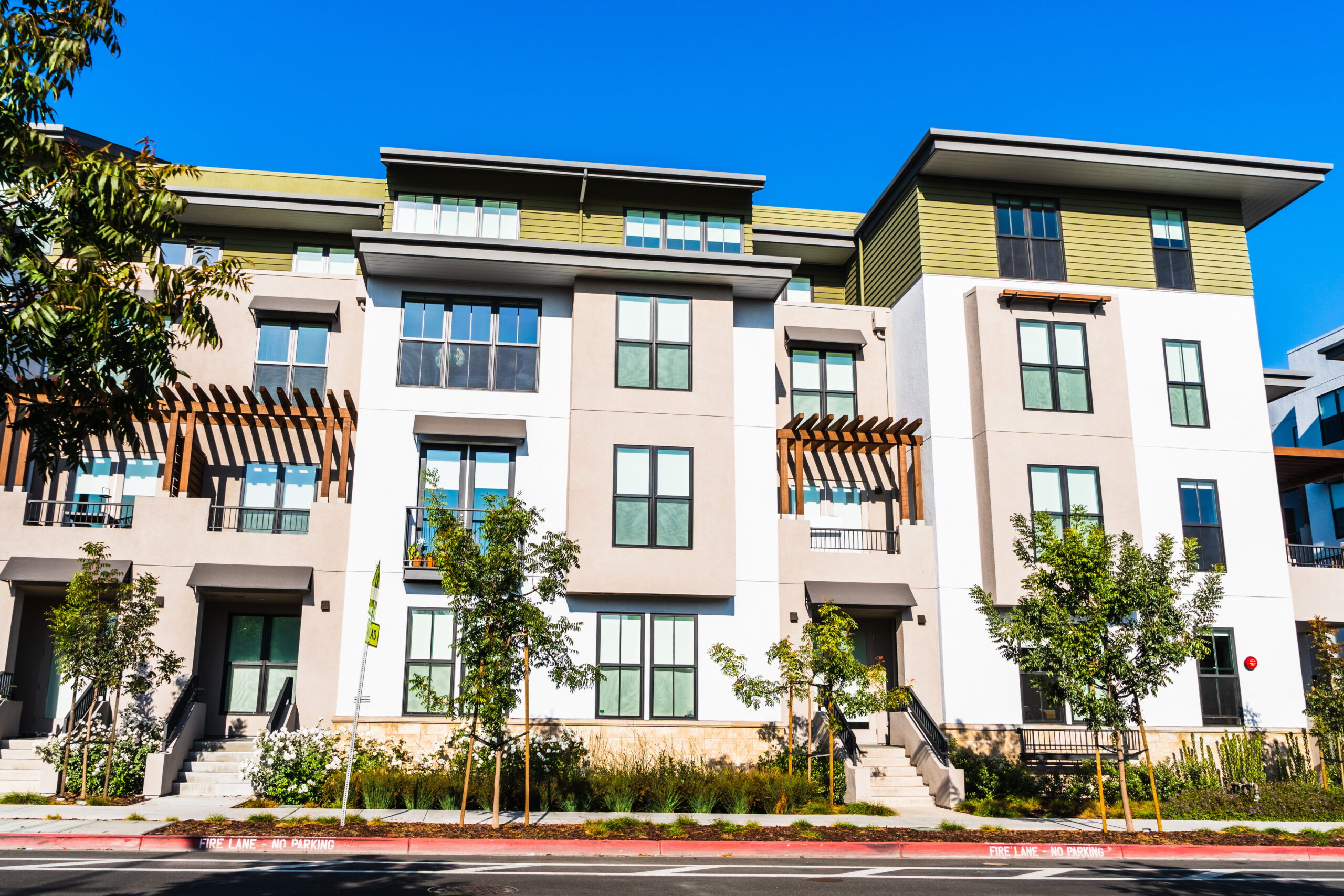 Flat image of multifamily housing white and tan