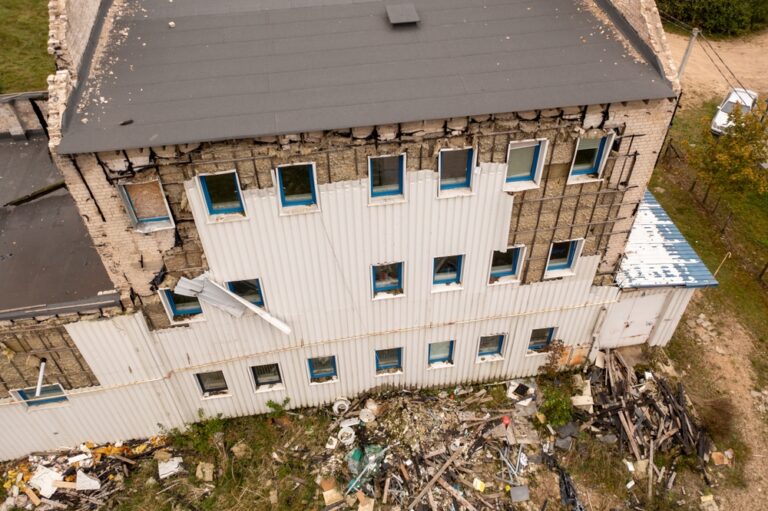 Drone photography of old abandoned factory house in ruins during autumn cloudy day