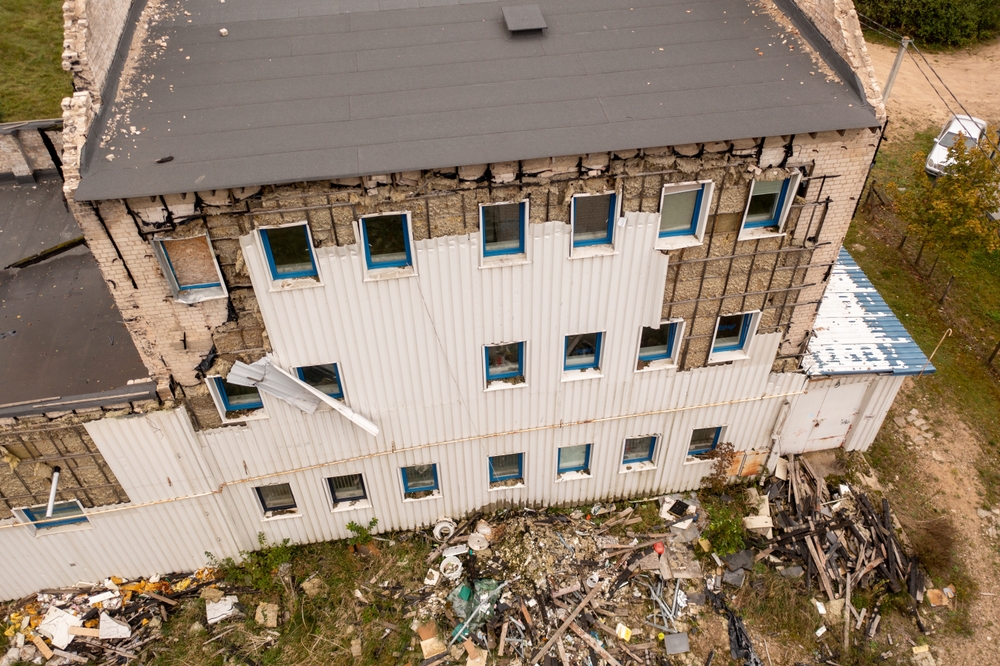 Drone photography of old abandoned factory house in ruins during autumn cloudy day